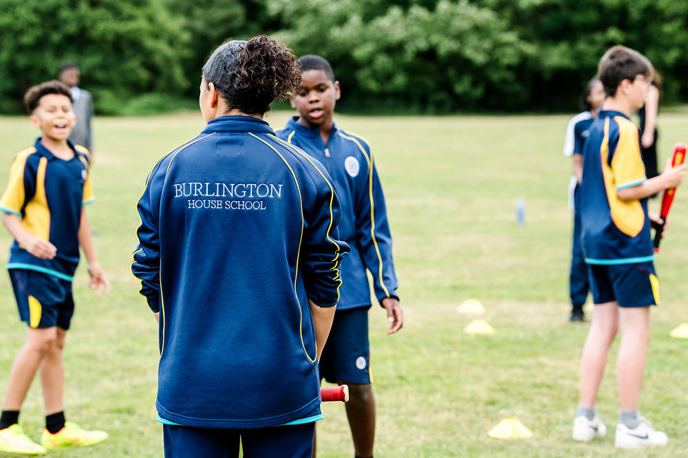 Group of students in PE session playing rounders
